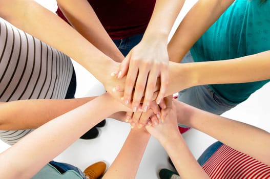 Five girls showing unity with their hands.