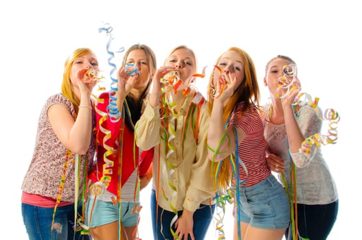 Five pretty teenager girl make party streamers and blow at the camera, isolated against white background.