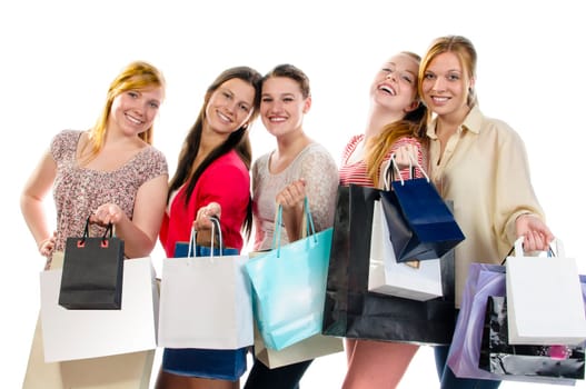Five girls out shopping and showing their shoppingbags. Isolated on a white background