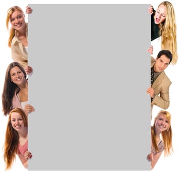 A group of six friends, five girls and a young man holding a blank sign together and laughing at the camera, isolated against white background.