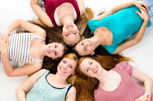 Group of friends with their heads together on the floor