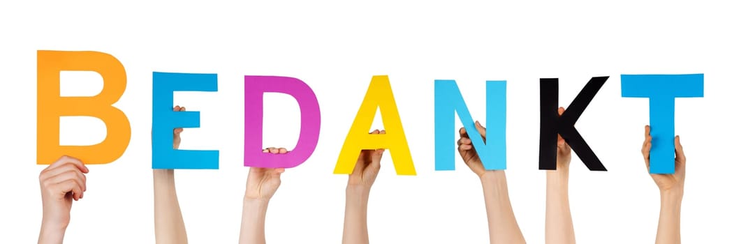 many hands holding the dutch word Bedankt which means thanks