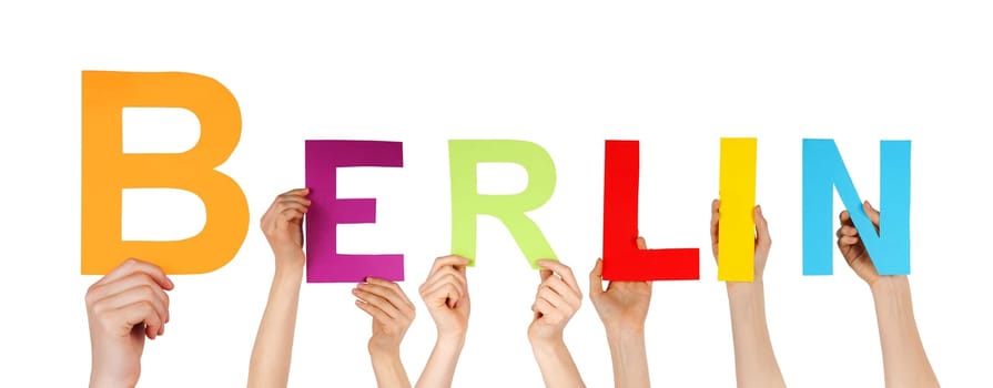 many hands holding the name of the german capital Berlin, isolated