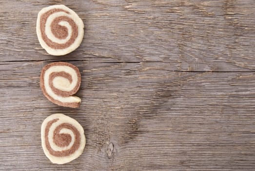 three cookies on wood as background with copy space