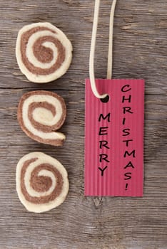 merry christmas wishes on a red banner with some cookies on a wooden background