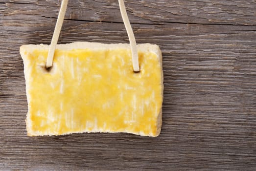 a hanging cookie with copy space on it on a wooden background