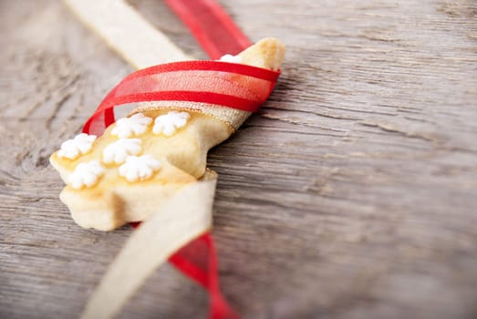 a christmas tree cookie in red and golden ribbon as ornamentation