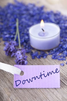a purple label on which stands downtime with a recreational background