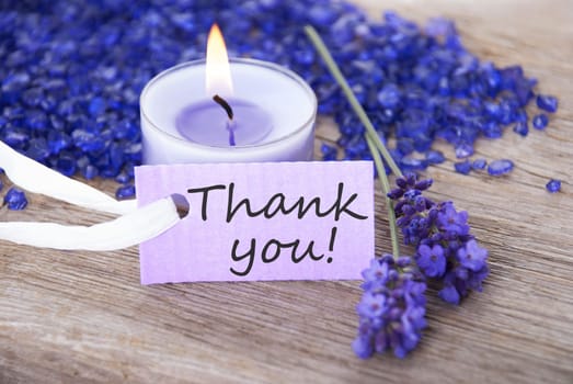 a purple label with candelligt background and the word thank you on it
