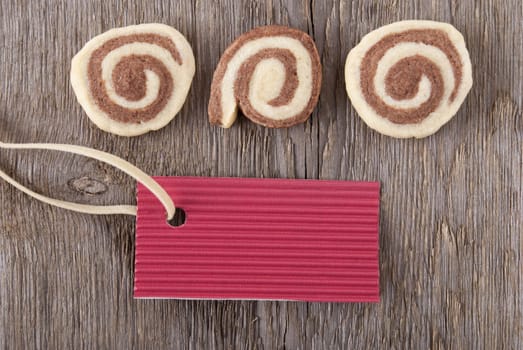 a blank red ticket with copy space and cookies on wood as background