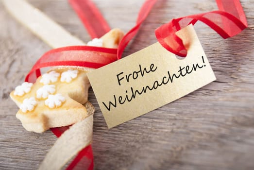 a golden label with the german words Frohe Weihnachten which means merry christmas