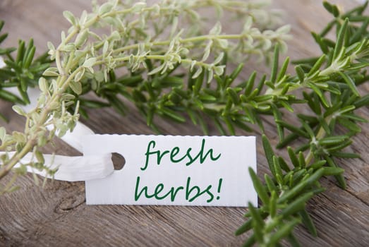 a white label with fresh herbs on it and herbs in the background