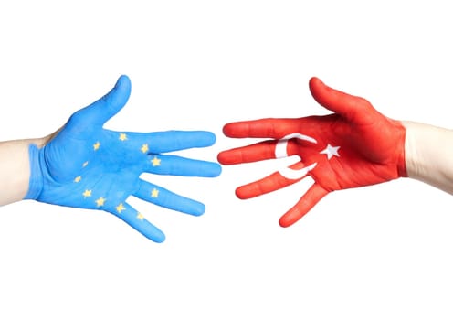 two hands, one painted with the european and one with the turkey flag on it