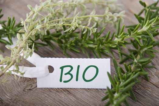 a white label with the word BIO on it and with herbs in the background