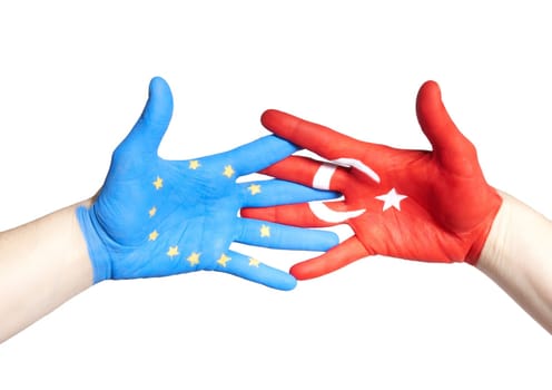 a turkey and a european hand holding each other