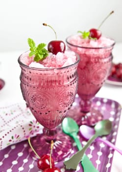 Two glasses with sorbet with cherry flavor and minze