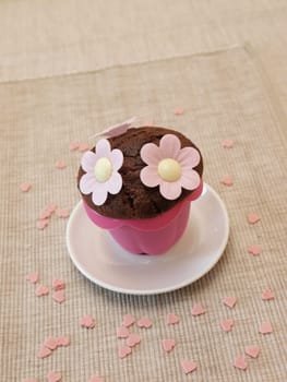 Sweet muffin with flowers and heart shapes