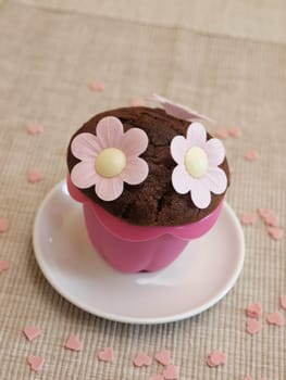 Sweet muffin with flowers and heart shapes
