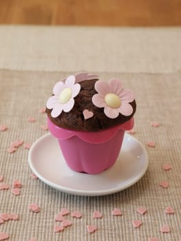 Sweet muffin with flowers and heart shapes