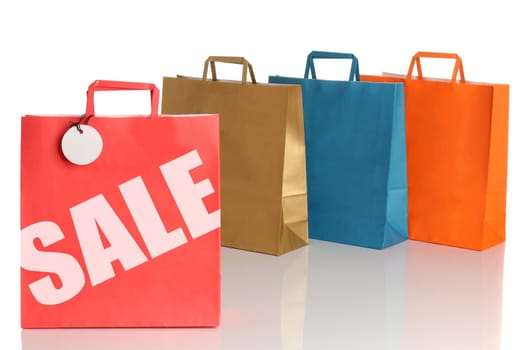 Assorted colored shopping bags over white background