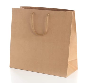 Paper shopping bag with  handles over white background.