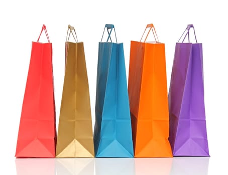 Assorted colored shopping bags over white background