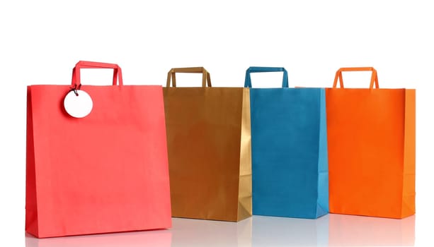 Assorted colored shopping bags over white background