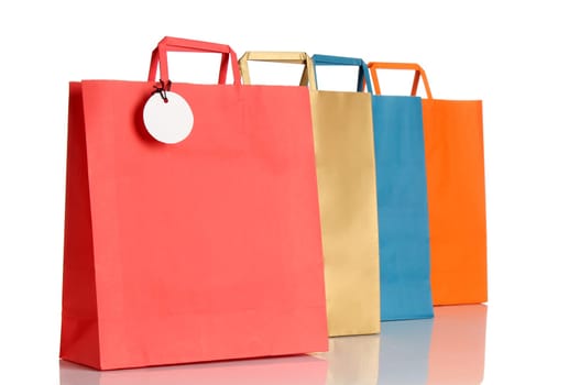 Assorted colored shopping bags over white background