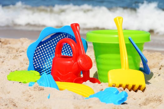 Plastic children toys on the sand beach
