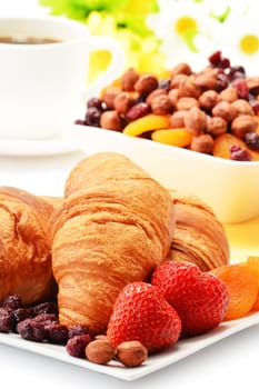 Breakfast with croissants, cup of coffee and fruits