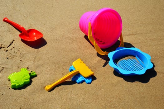 Plastic children toys on the sand beach