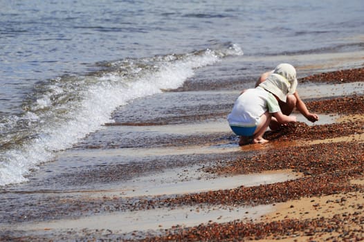 Two little boys playing on the sand beach