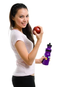 Healthy lifestyle concept. Fitness woman eating apple smiling happy looking at camera. Pretty mixed race Caucasian Southeast Asian woman isolated on white background.