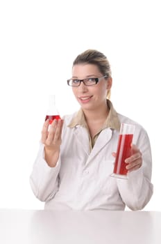 attractive young chemical laboratory assistant with blond hair and glasses works with various coloured liquids in test tubes,exposed against a white background