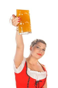 Young attractive woman with blond hair and braids wears a colorful dirdl dress and holds a mug of freshly tapped beer in her hand,exposed against a white background.