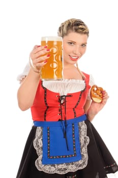 Young attractive woman with blond hair and braids wears a colorful dirdl dress and holds a pretzel and a beer mug with freshly tapped beer in her hand,exposed against a white background.