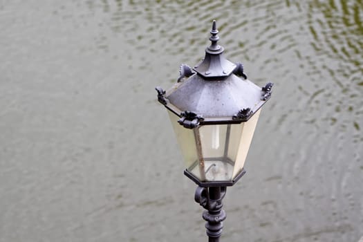 Lantern in front of water surface