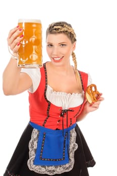 Young attractive woman with blond hair and braids wears a colorful dirdl dress and holds a pretzel and a beer mug with freshly tapped beer in her hand,exposed against a white background.