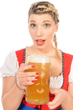 Young attractive woman with blond hair and braids wears a colorful dirdl dress and holds a mug of freshly tapped beer in her hand,exposed against a white background.