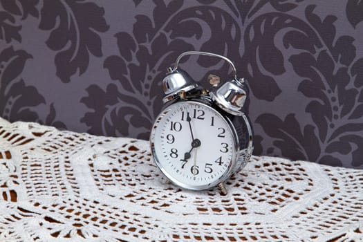 Nostalgic alarm clock on crochet blanket