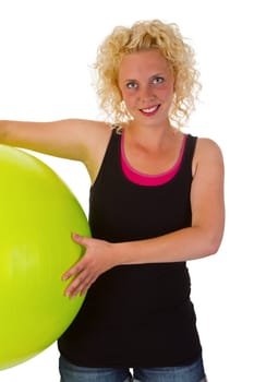 Young woman with gymnastics ball exempted on white background