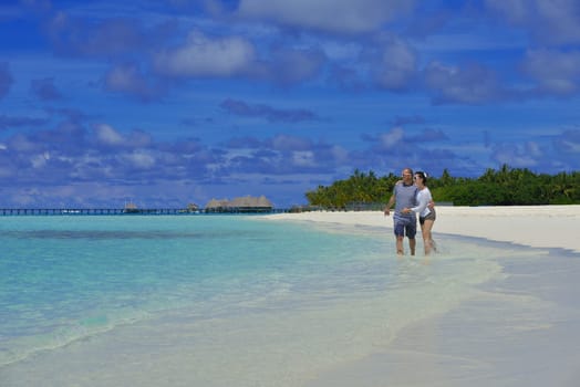 happy young  couple at summer vacation have fun and relax at beautiful sunny  day on beach