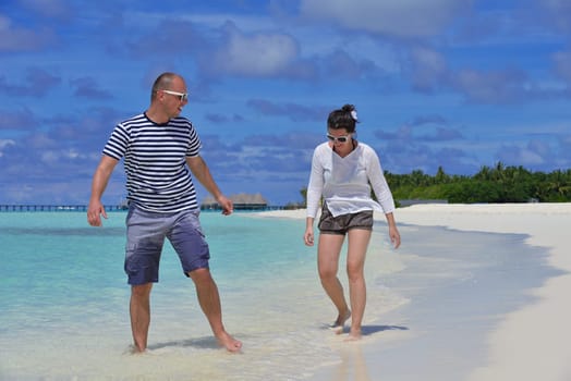 happy young  couple at summer vacation have fun and relax at beautiful sunny  day on beach