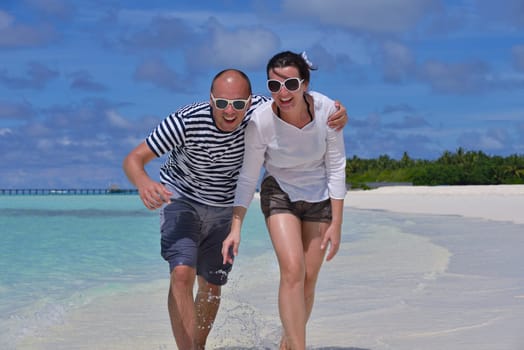 happy young  couple at summer vacation have fun and relax at beautiful sunny  day on beach