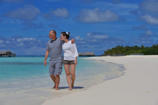 happy young couple have fun and relax at summer vacation on background maldives travel location and beautiful white sand beach