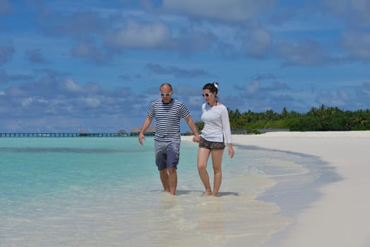 happy young  couple at summer vacation have fun and relax at beautiful sunny  day on beach