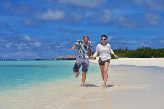 happy young  couple at summer vacation have fun and relax at beautiful sunny  day on beach