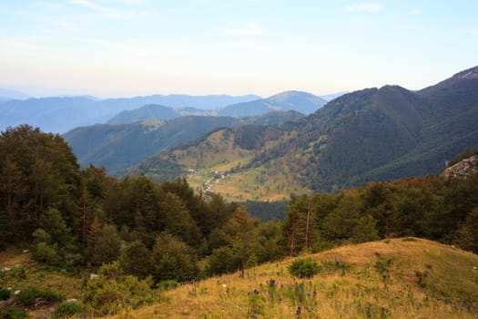 Mountain and Tolmiske Ravne town in Slovenia