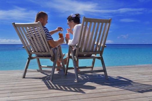 happy young couple have fun and relax at summer vacation on background maldives travel location and beautiful white sand beach