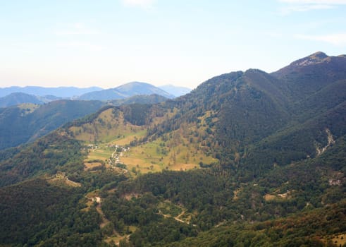 Mountain and Tolmiske Ravne town in Slovenia